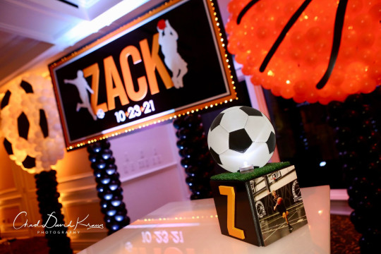 Beautiful Soccer Themed LED Mini Cube with Glitter Initial, Photo and Soccer Ball Over Turf Topper, Custom Backdrop Over Balloon Base and Sports Themed Balloon Sculptures for Bar Mitzvah Lounge Set Up