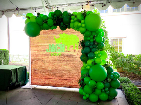 Jungle Theme Organic Half Balloon Arch with Greenery Over Custom Vinyl Backdrop for Tent Party Decor