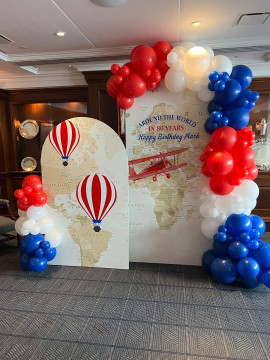 Travel Themed Photo Backdrop with Custom Chiara Arches & Organic Balloon Garland