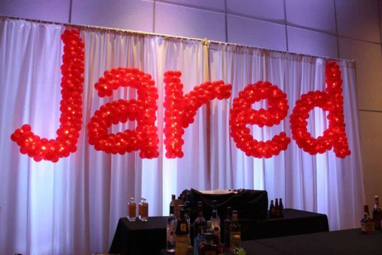 Red Name in Balloons Sculpture with Lights on LED Curtain