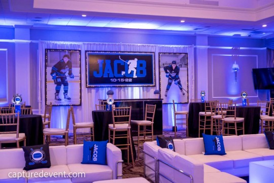 Hockey Themed Backdrop with Blowup Photos on LED Curtain for Bar Mitzvah at Cedar Hill Country Club