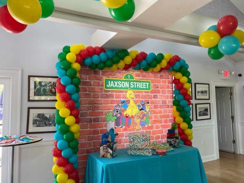 Sesame Street Balloon Arch with Custom Themed Backdrop for First Birthday Dessert Table