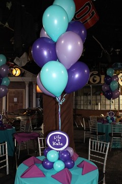 Purple & Turquoise Balloon Centerpieces with Cutout Logos in Balloon Bases