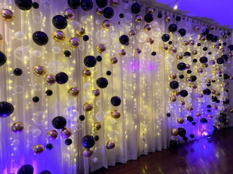 Black & Gold Balloon Bubble Wall with Twinkle Lights & Neon Sign for Engagement Party