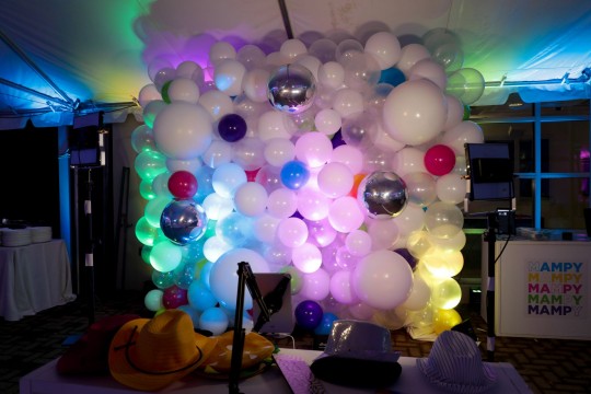 Beautiful White & Clear Balloon Wall with Blue, Green, Pink, Purple and Yellow Accents and Metallic Silver Orbz as Photo Op for Tent Party Decor