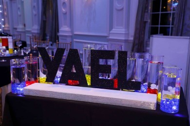 Black Glitter Name Display with Primary Colored LED Cylinders for Bat Mitzvah Candle Lighting Display