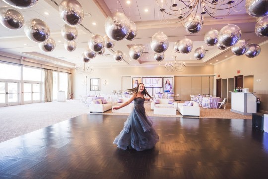 Beautiful Metallic Silver Orbz Ceiling Treatment for Bat Mitzvah Decor with Custom Backdrop & Blow Up Pictures, Custom Cube Cocktail Centerpiece and Custom Lounge Set Up with Pillows
