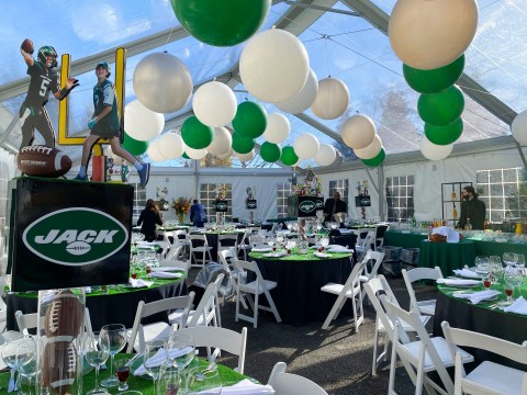 Beautiful Football Themed Tent Bar Mitzvah with Green, Silver & White Balloons Over Ceiling and Custom Football Centerpiece with Logo Cube and Cut Outs