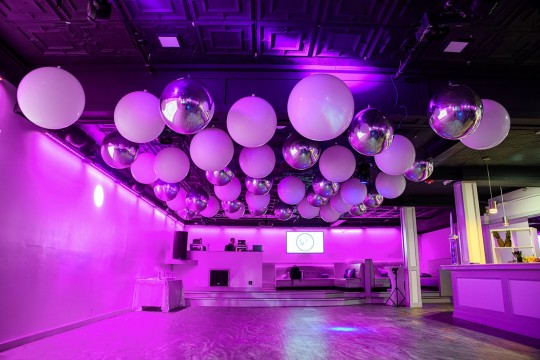 Classic Dance Floor Ceiling Treatment with White 3' Balloons & Silver Metallic Orbz and Lavender Up Lighting Around Room for Bat Mitzvah Party Decor
