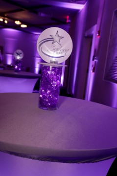 Beautiful Star Themed LED Custom Mini Logo Topper Centerpiece Over Purple Chips for Bat Mitzvah Lounge Set Up