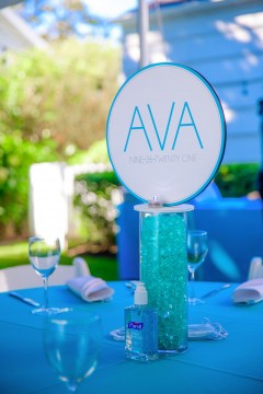Beautiful LED Logo Centerpiece Over Turquoise Chips Filled Cylinder for Tent Party Lounge Set Up