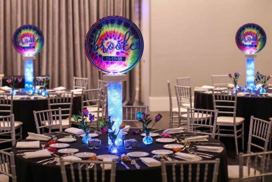 Tie Dye Logo Centerpieces on LED Vases with Gems accented with Tie Dye Roses