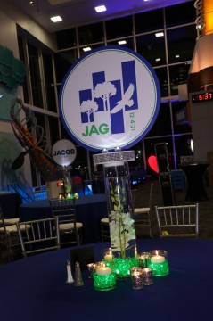 LED Custom Logo Centerpiece with Bling Base on Cylinder with Orchids, Silver Votives and Floating Candles