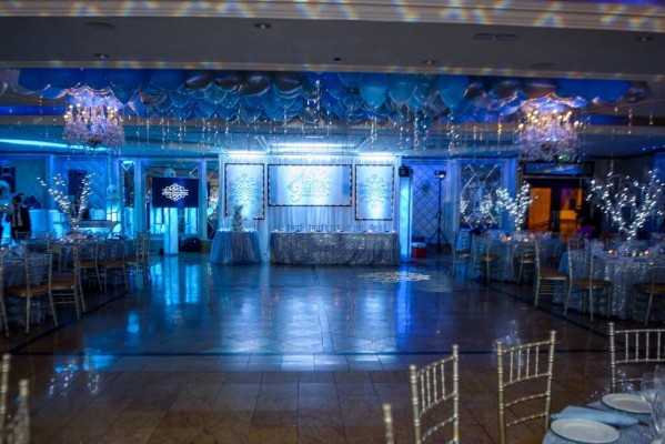 Winter Themed Sweet 16 with Ceiling Balloons, LED Tree Centerpieces, Custom Backdrop and Blue Lighting at Seasons Catering