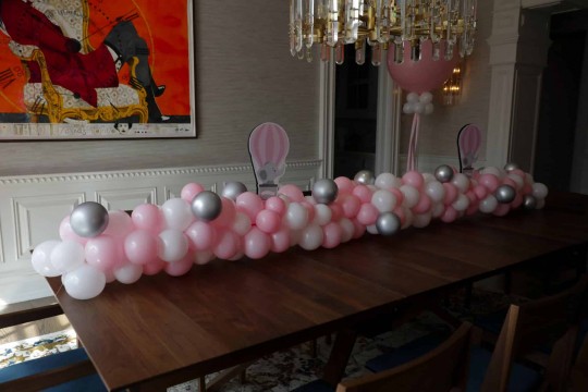 Balloon Garland with Elephant Logo Toppers over Table for Baby Shower