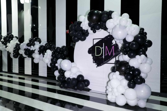 Organic Black & White Half Arch Over Custom Acrylic Wall and Organic Black & White Balloon Garland