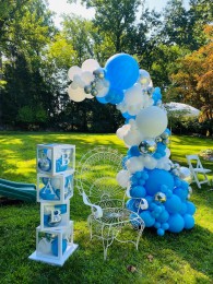 Organic Half Balloon Arch With Baby Blocks and White Metal Chair for Baby Shower Outdoor Decor