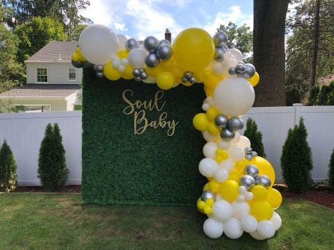 Organic Balloon Garland over Greenery Backdrop with Custom Cut Out Sign