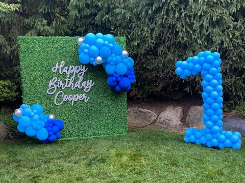 Organic Balloon Garland Over Greenery Wall with Custom Cut Out Sign & Number Balloon Sculpture