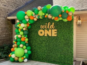 Animal Print Organic Half Balloon Arch over Greenery Wall with Custom Cut Out Sign