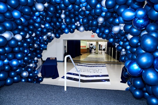 Fun Metallic Blue Balloon Tunnel around Stairs for Corporate Event