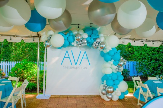Beautiful White and Blue Organic Half Balloon Arch with Metallic Silver Accents Over Step and Repeat and Large Balloons Ceiling Treatment for Tent Party