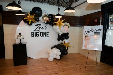 Organic Balloon Half Arch with Spike Balloons and Custom Cut Out Over Acrylic Wall with Custom Sign