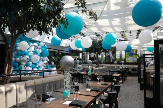 Balloon Wall, Ceiling Treatment and Centerpieces for Soccer Themed Tent Party