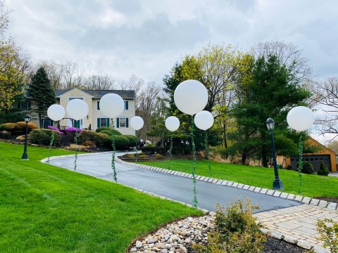Free Standing Balloons with Greenery Around Driveway