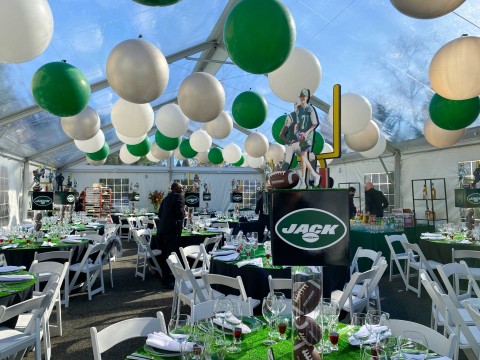 Jets Themed Tent Party with Large Balloons Ceiling Treatment, Turf Table Topper and Jets Centerpiece with Football Filled Cylinders, Custom Logo Cube and Custom Cut Outs