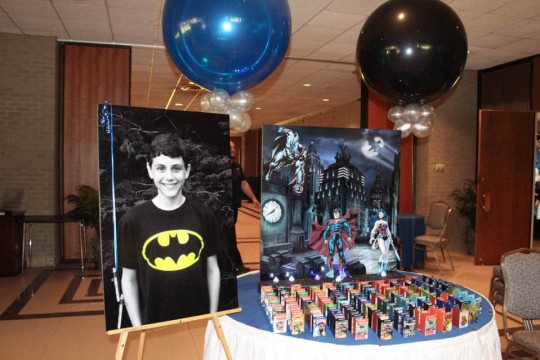 Comic Book Themed Seating Card Display with Gotham City Background & Photo Cutouts