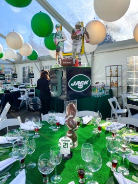 Custom Nets Themed Logo Cube Centerpiece with Cut Outs on Football Filled Cylinder and Turf Table Topper for Outdoor Bar Mitzvah Decor