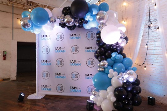 B'nei Mitzvah Step & Repeat with Blue, Black & White Organic Balloon Garland at Art Factory